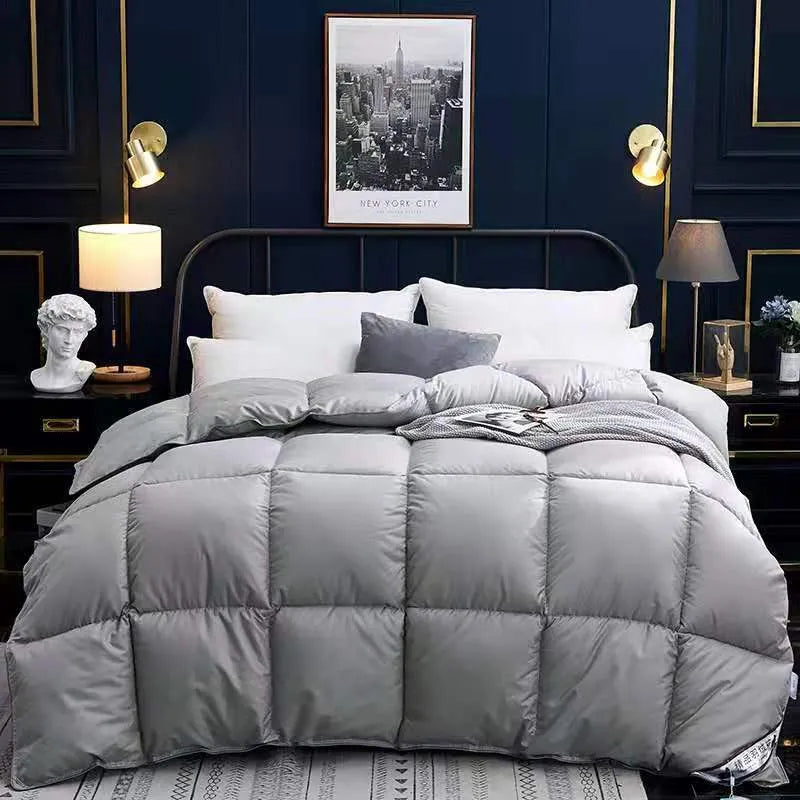 Goose down winter duvet in beige colour on a bed
