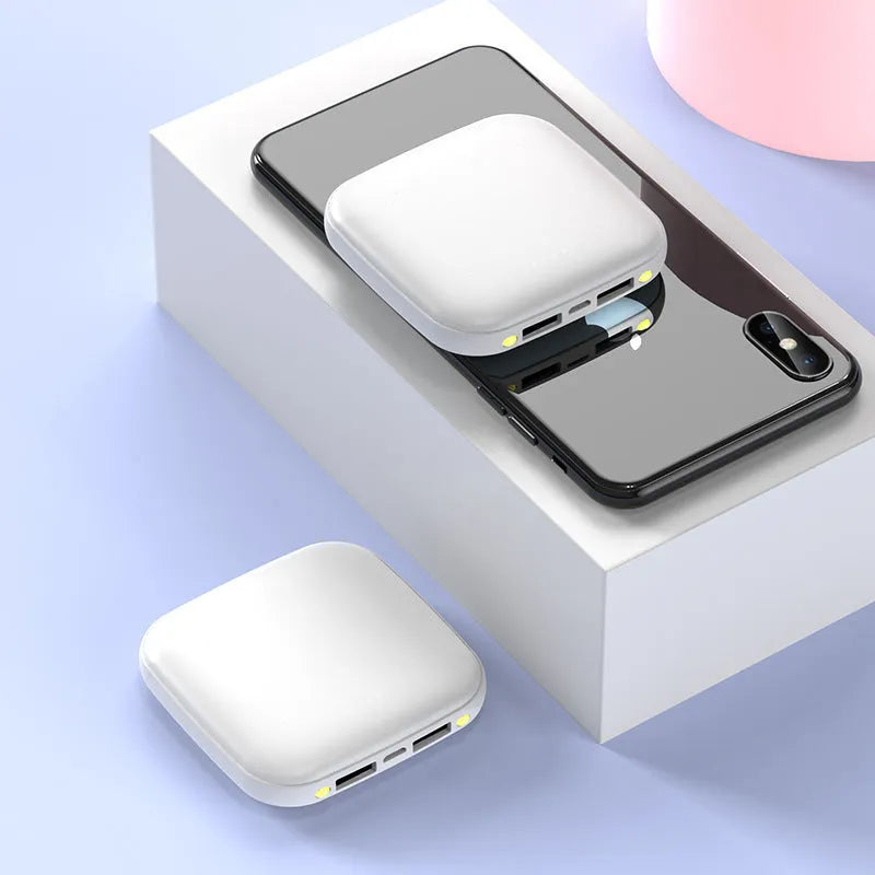 Compact black mini power bank with LED flashlight showing size scale
