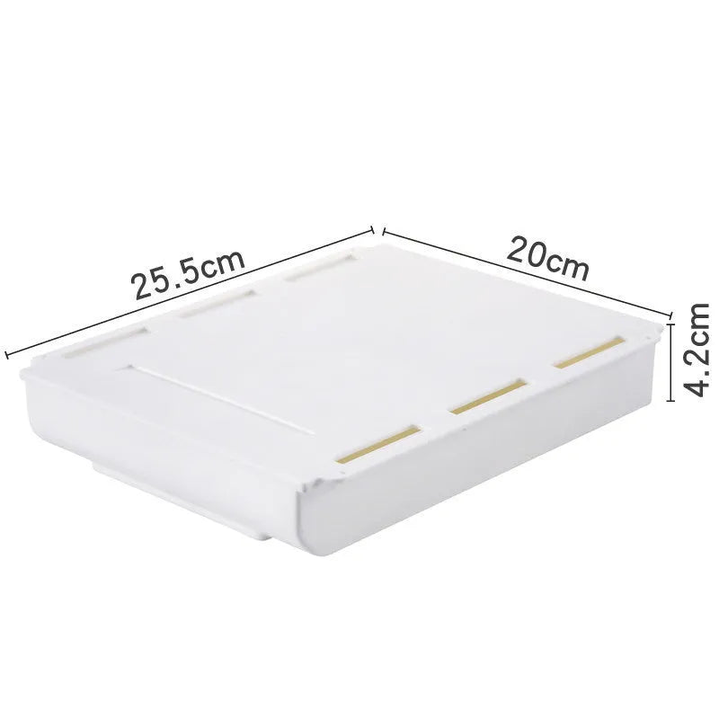 Japanese style plastic drawer storage box in grey placed under a table with stationery organised inside