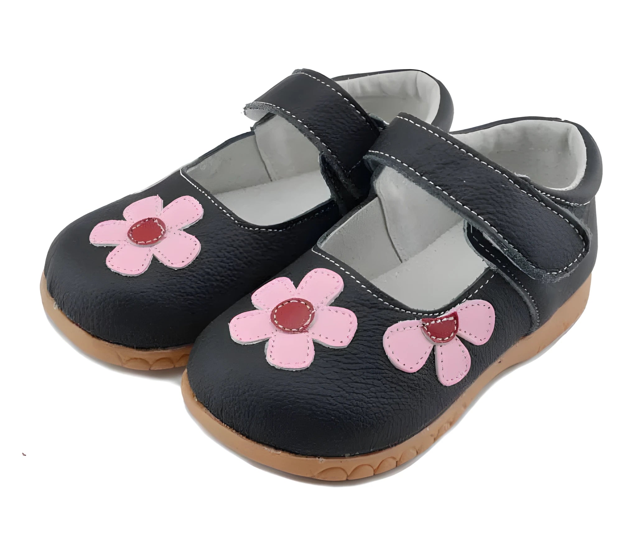 A child's black leather princess shoe with embroidery and a Velcro strap fastener.