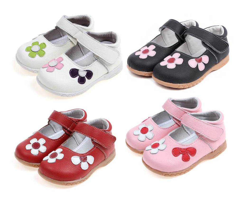 A child's black leather princess shoe with embroidery and a Velcro strap fastener.