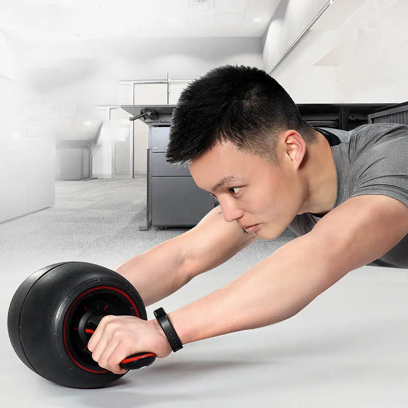 Home abdomen recuperation fitness wheel with black PP inner ring and TPE outer ring on a carpet