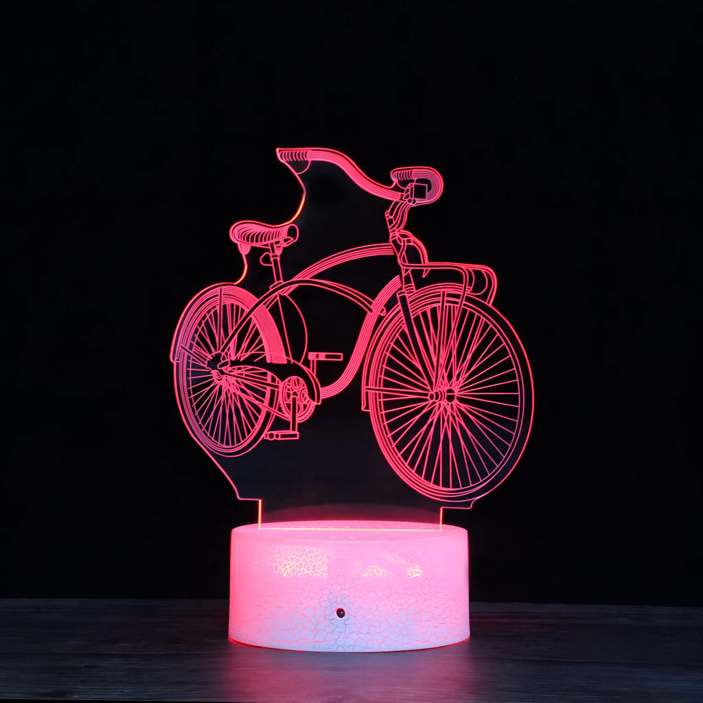 3D bicycle night light with LED acrylic shade on black base against a dark background