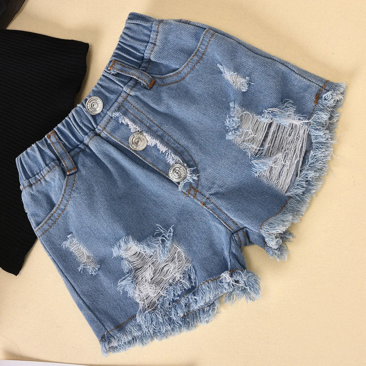 Black children's two-piece suit with striped top, mesh sleeves, and ripped denim shorts.