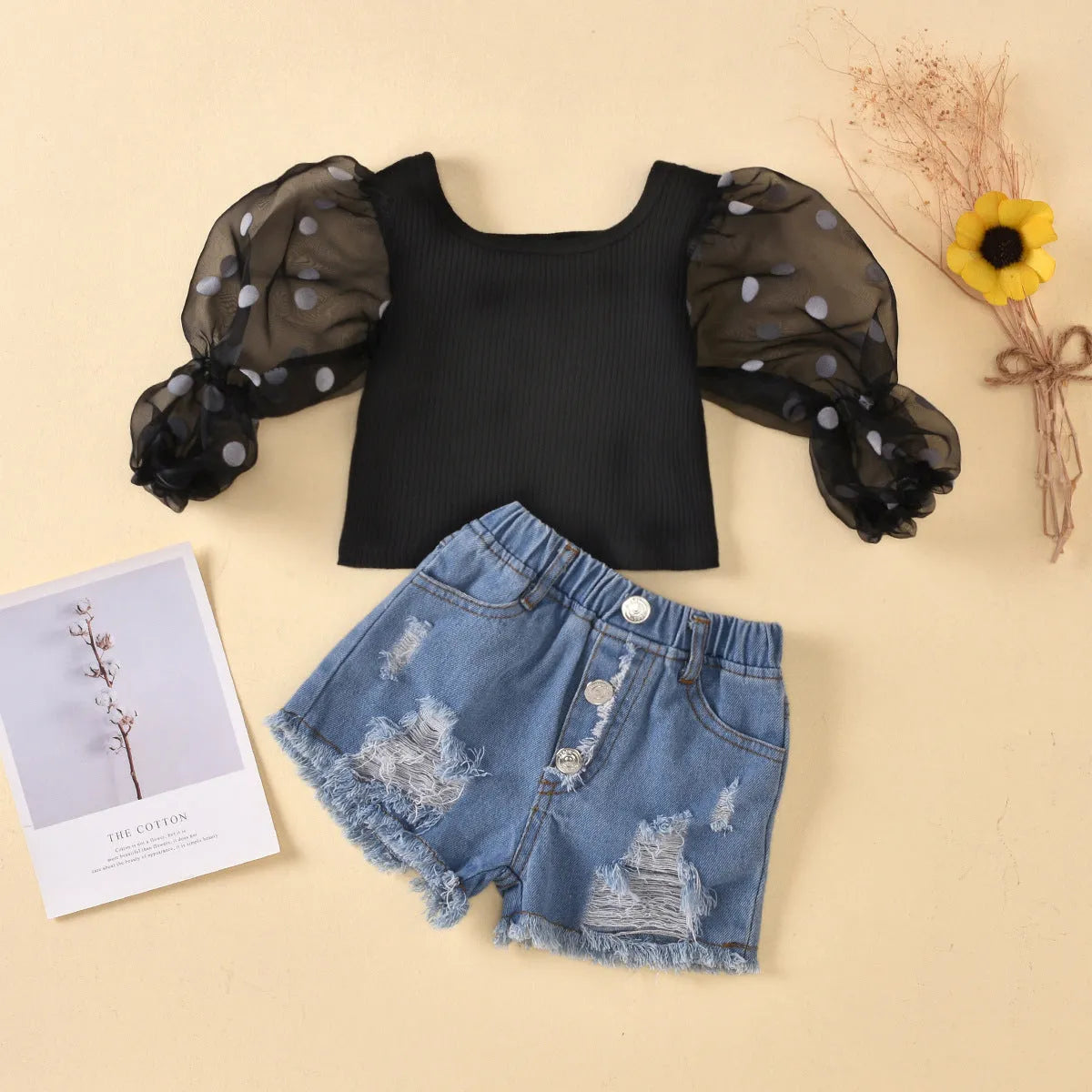 Black children's two-piece suit with striped top, mesh sleeves, and ripped denim shorts.