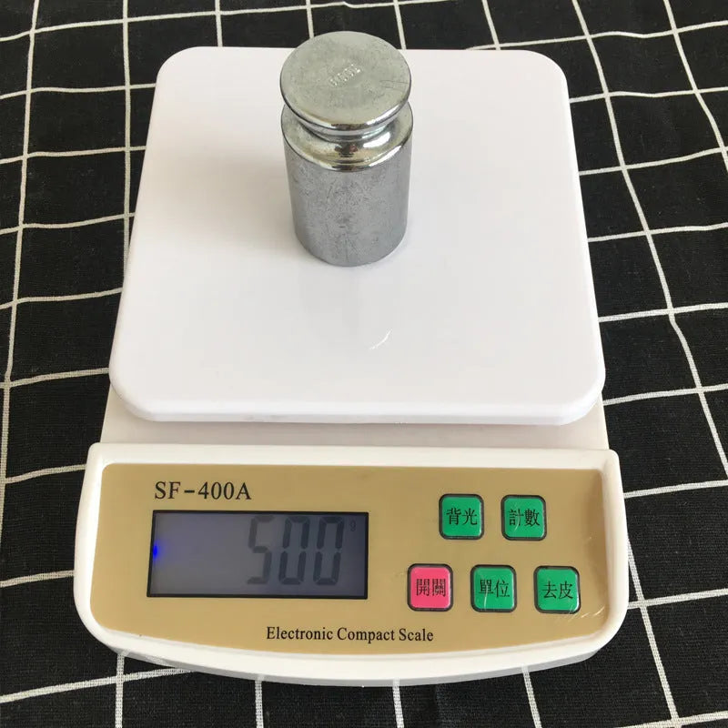 SF-400A black electronic kitchen scale on a countertop displaying a weight reading.