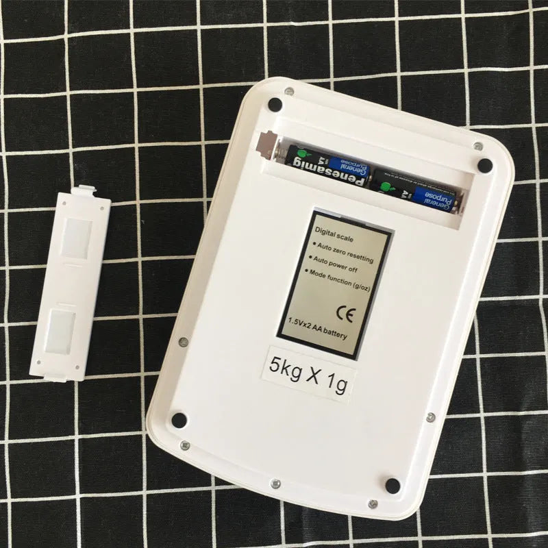 SF-400A black electronic kitchen scale on a countertop displaying a weight reading.