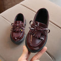 Childrens vintage synthetic leather sneakers in brown with car suture detailing, low-top design
