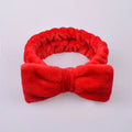 Coral velvet butterfly end hair band with letter text design in pink colour on neutral background