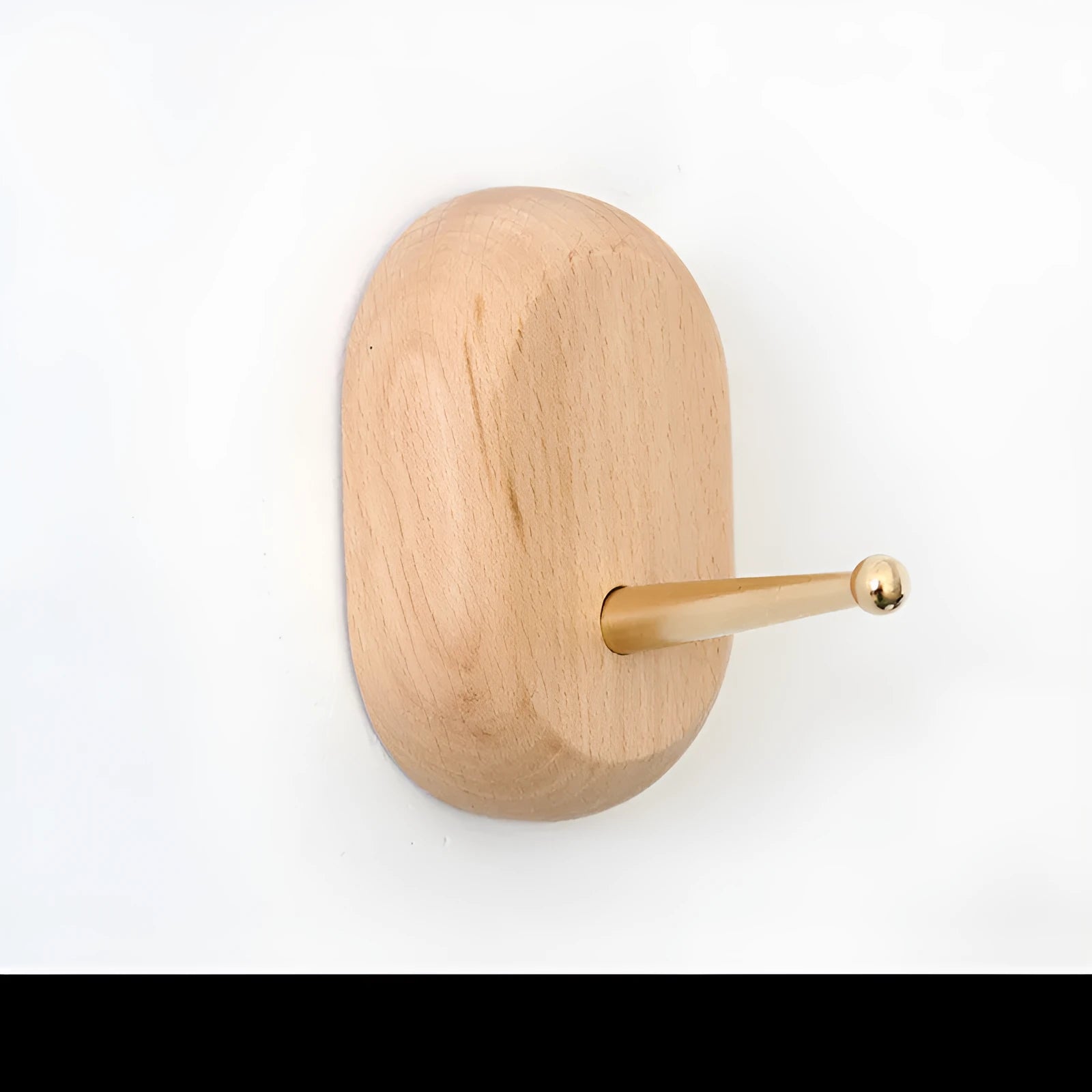 Beech wood and brass adhesive wall hook in one of five shapes: round, capsule, oval, diamond, or square.
