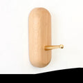 Beech wood and brass adhesive wall hook in one of five shapes: round, capsule, oval, diamond, or square.