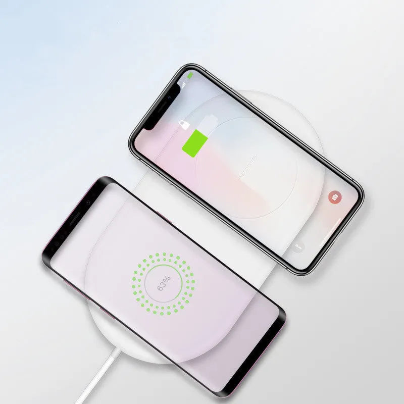 Simple white dual wireless fast charger for two mobile phones on a table