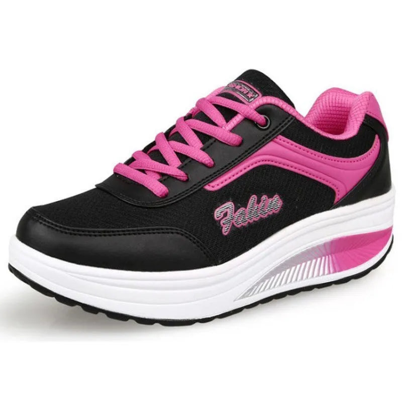 Women's grey and black casual sports shoes with a medium heel on a plain background