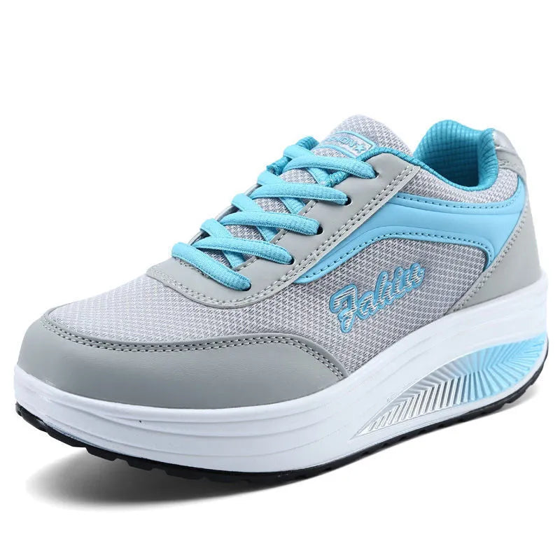 Women's grey and black casual sports shoes with a medium heel on a plain background