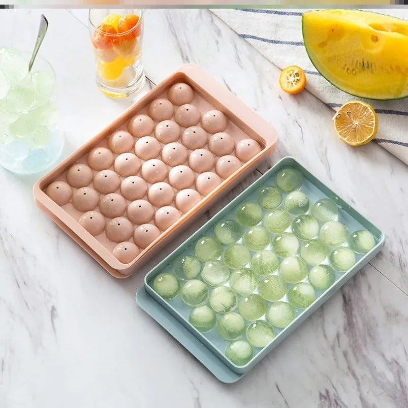 Sky blue and pink 3D round ice cube moulds with spherical cavities