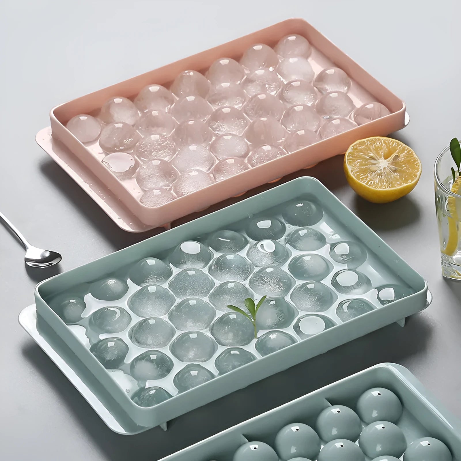 Sky blue and pink 3D round ice cube moulds with spherical cavities