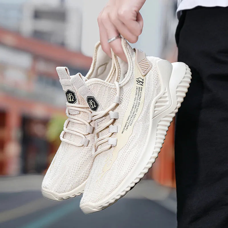 Men's white mesh sports shoe with rubber sole and round toe on a plain background.