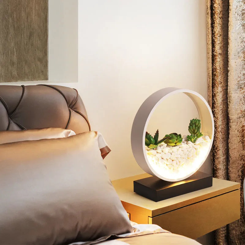 Black table lamp with metal lamp holder and push button switch on bedside table