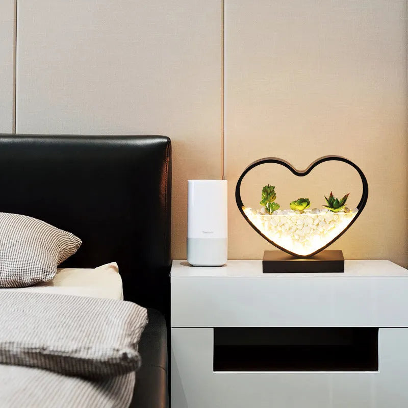 Black table lamp with metal lamp holder and push button switch on bedside table