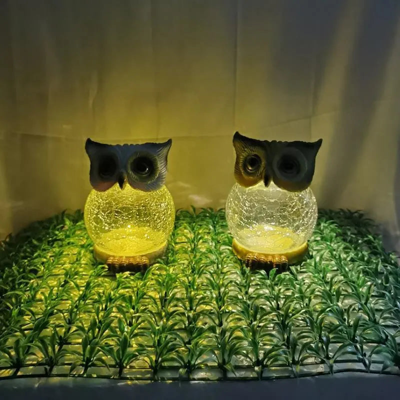 White solar-powered LED owl light for outdoor garden decoration with realistic details