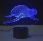 Colourful LED 3D table lamp with touch controls and remote on wooden desk