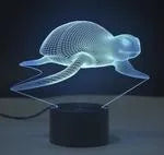 Colourful LED 3D table lamp with touch controls and remote on wooden desk
