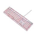 Pink and silver mechanical keyboard with green switches and matching wireless mouse on a desk.