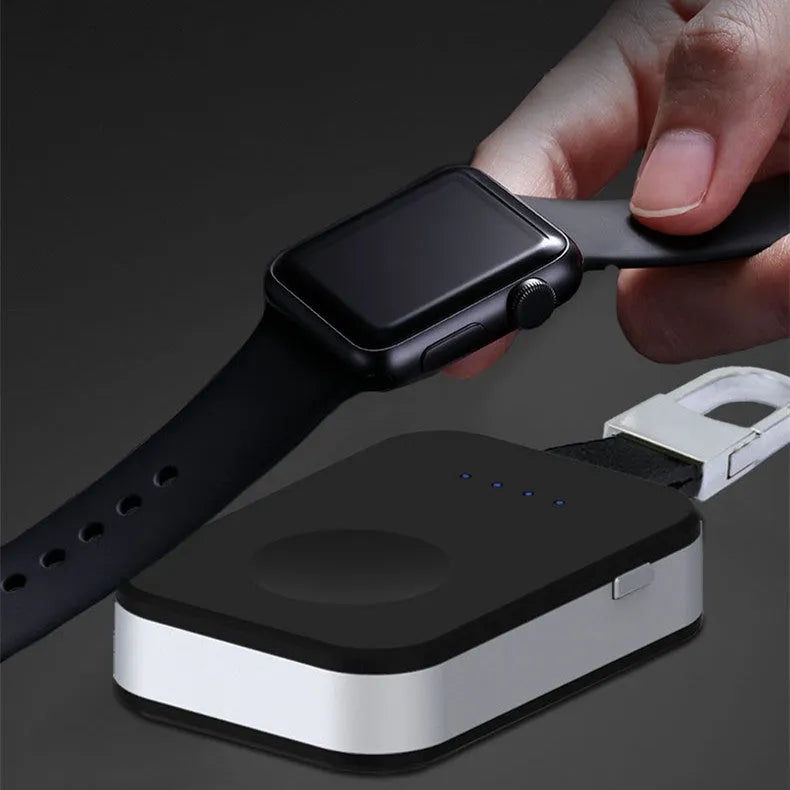 Black Apple Watch wireless charging power bank on a keychain, showing compact size.