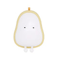 Pear-shaped silicone night light with warm yellow glow on a bedside table.