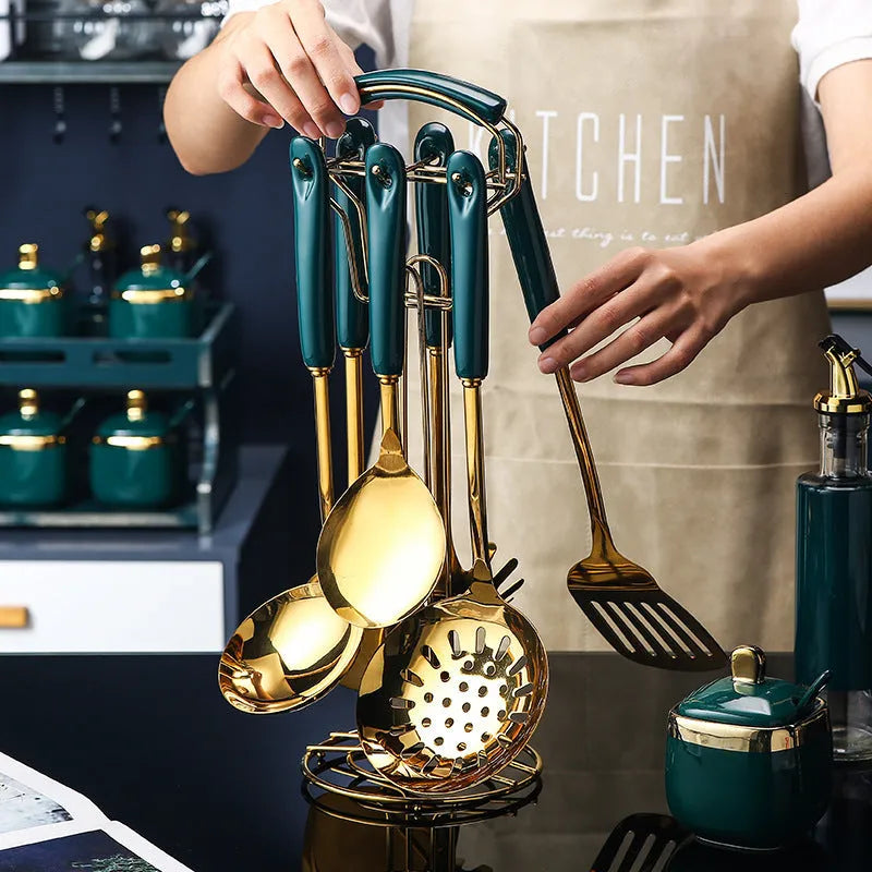 Seven-piece stainless steel kitchen utensil set with silicone handles including spatula, ladle, and pasta server.