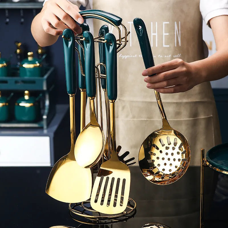 Seven-piece stainless steel kitchen utensil set with silicone handles including spatula, ladle, and pasta server.