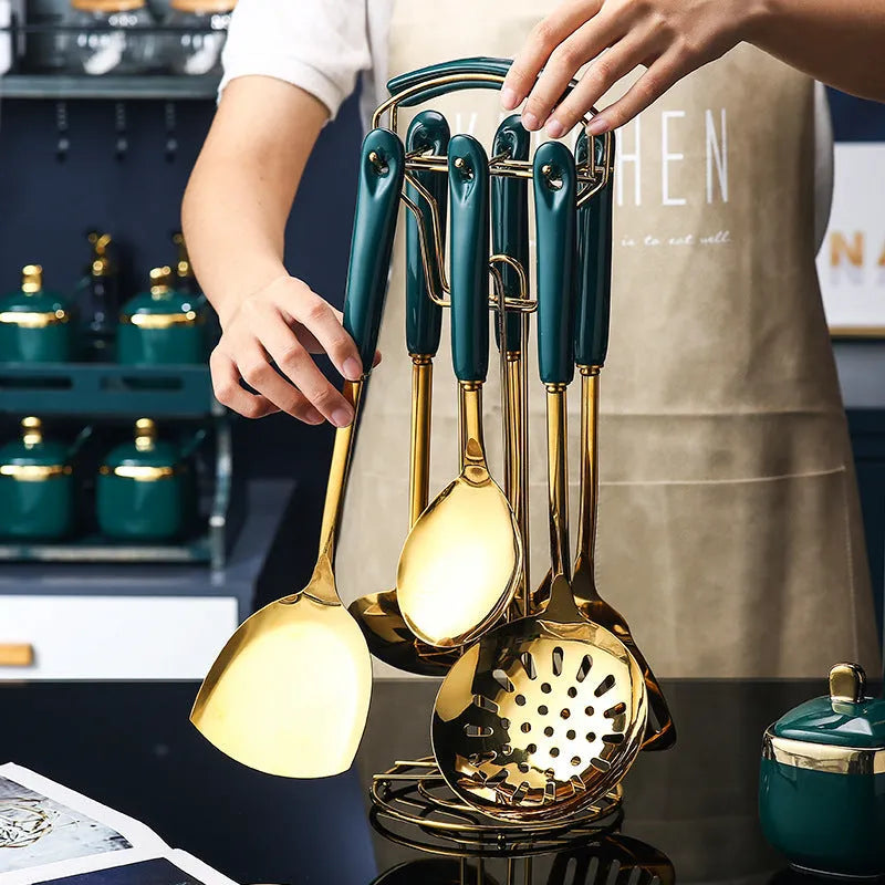 Seven-piece stainless steel kitchen utensil set with silicone handles including spatula, ladle, and pasta server.