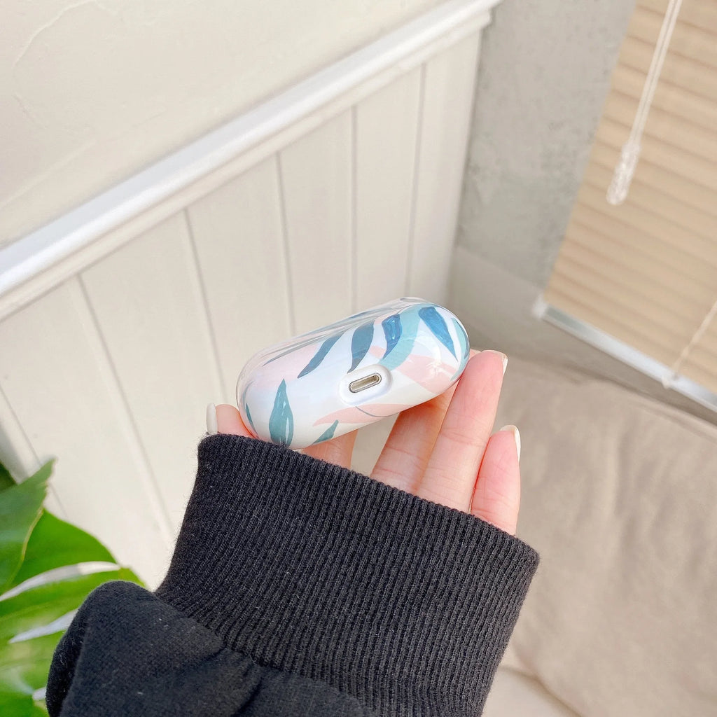 AirPods case with blue and green banana leaf tropical pattern on a TPU protective cover.