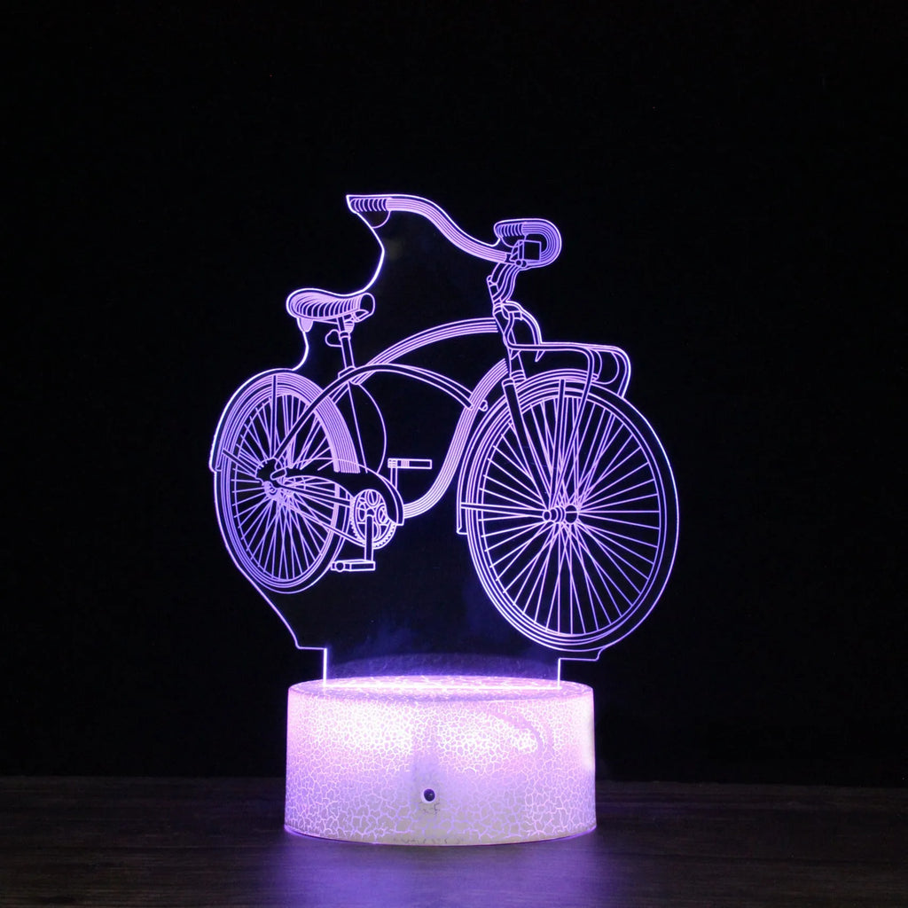 3D bicycle night light with LED acrylic shade on black base against a dark background