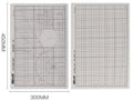 Green A3 self-healing cutting mat with centimetre grid for craft knives on a desk
