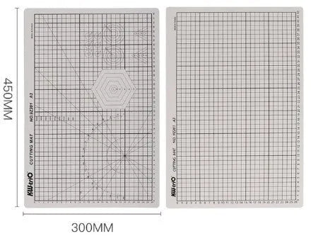 Green A3 self-healing cutting mat with centimetre grid for craft knives on a desk