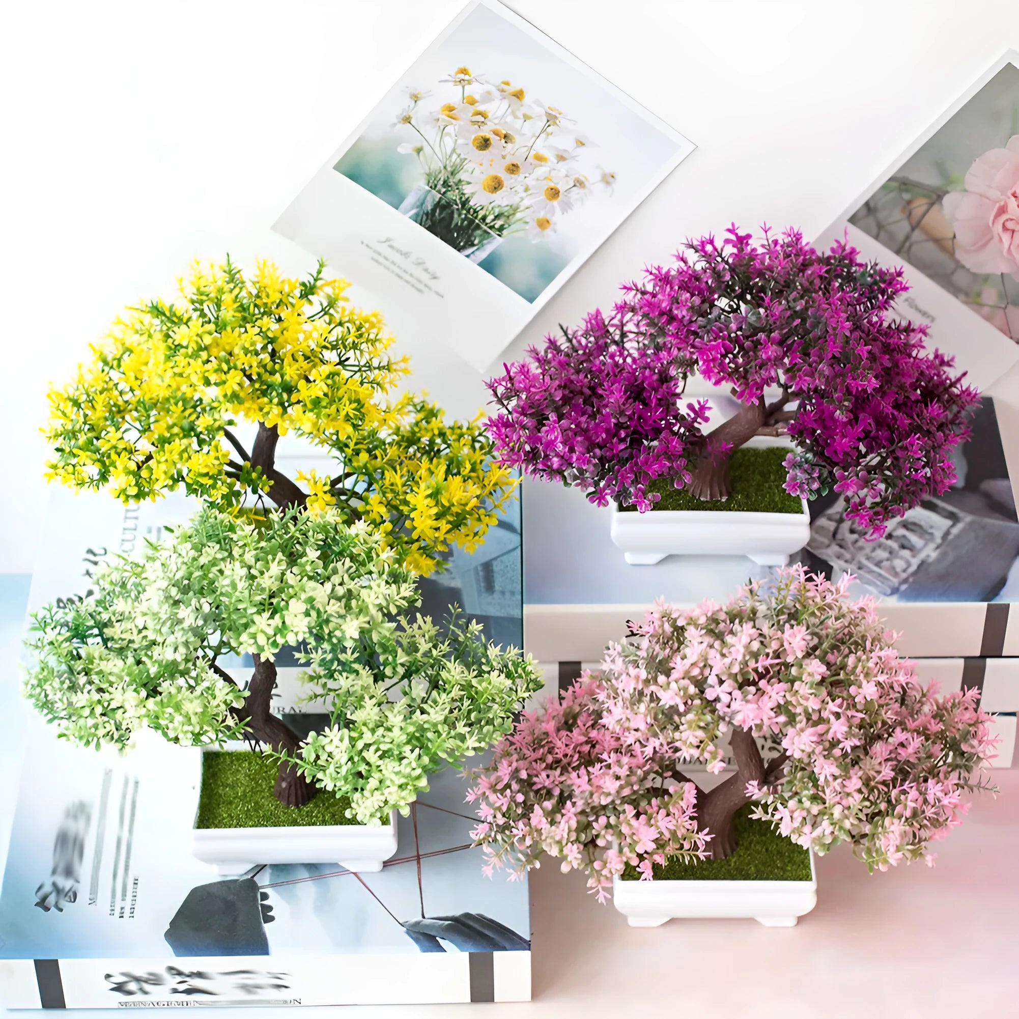 Artificial plastic flower bouquet in bonsai potted plant style with pink and white blooms