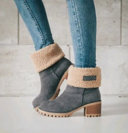 Women's suede mid-calf snow boots with thick flat sole in black, shown from the side.