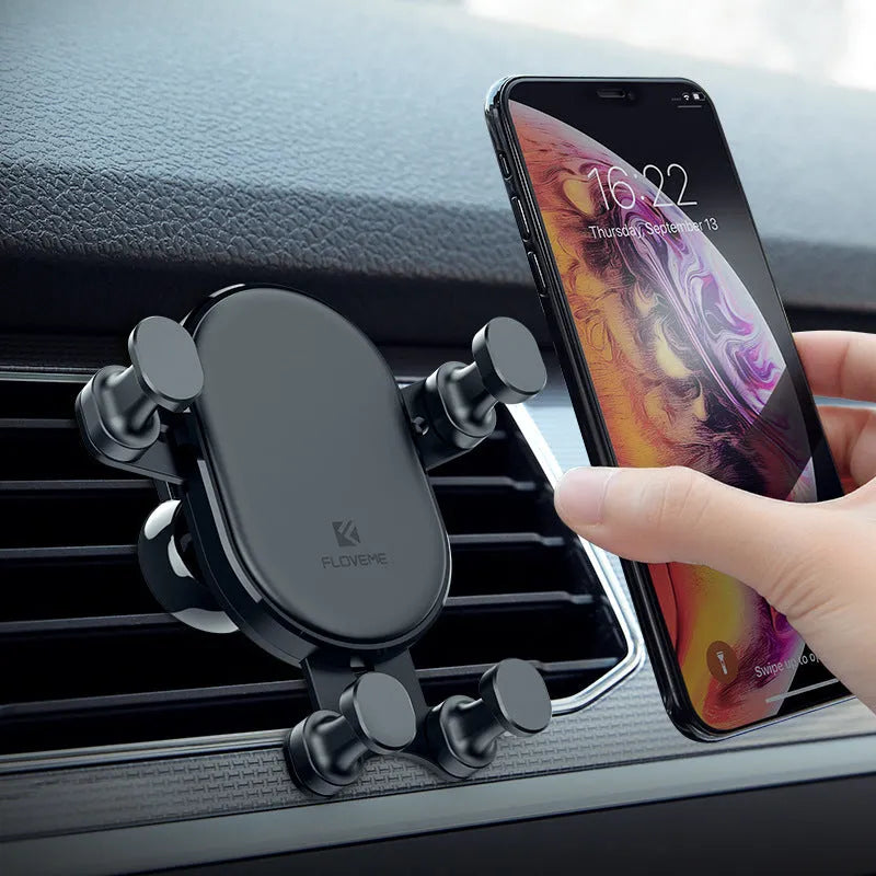 Black car phone holder with gravity bracket mounted on a car dashboard