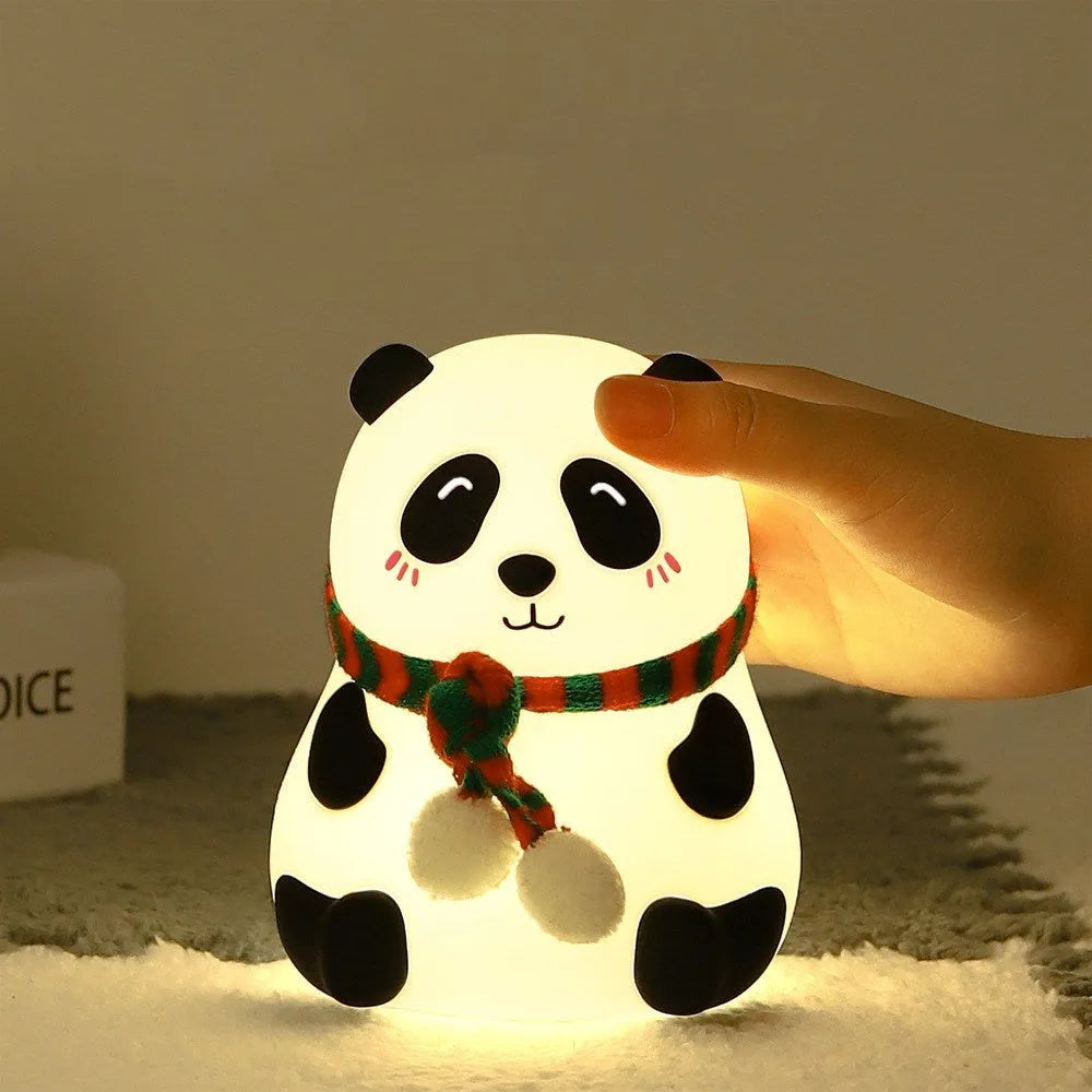 Panda-shaped soft silicone night light with USB rechargeable battery on a table.