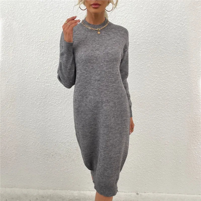Grey women's crew neck long sleeve acrylic pullover sweater on a hanger.
