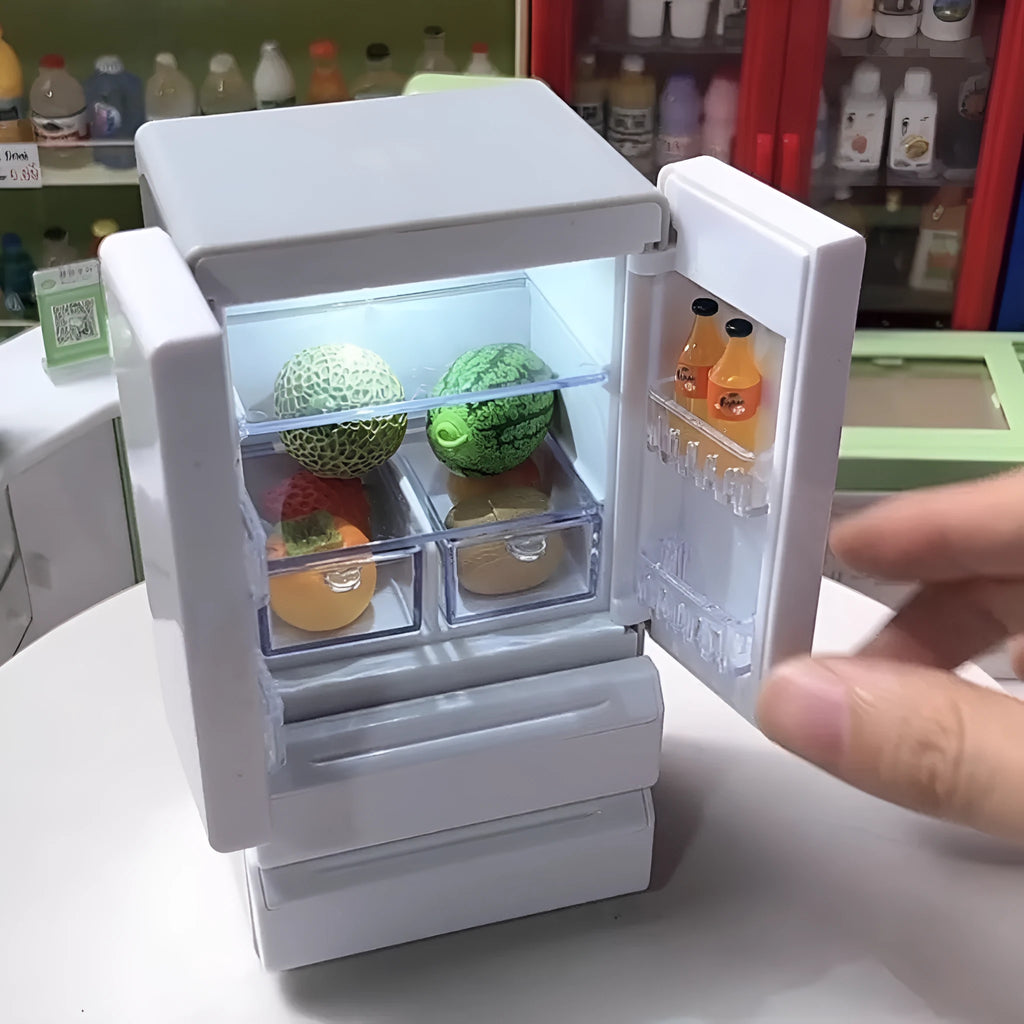White plastic miniature candy toy model with light-up feature on display.