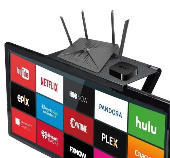 Black adjustable screen top shelf mounted on a monitor holding a streaming device and remote