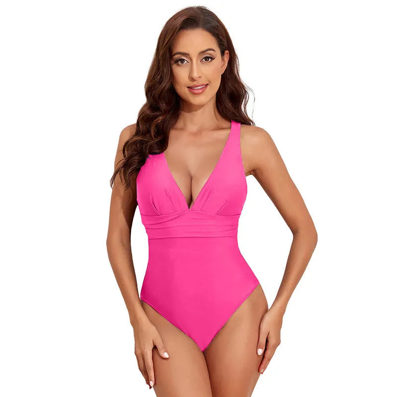 Minimalist solid colour cross-shoulder one-piece swimsuit for women on a mannequin.