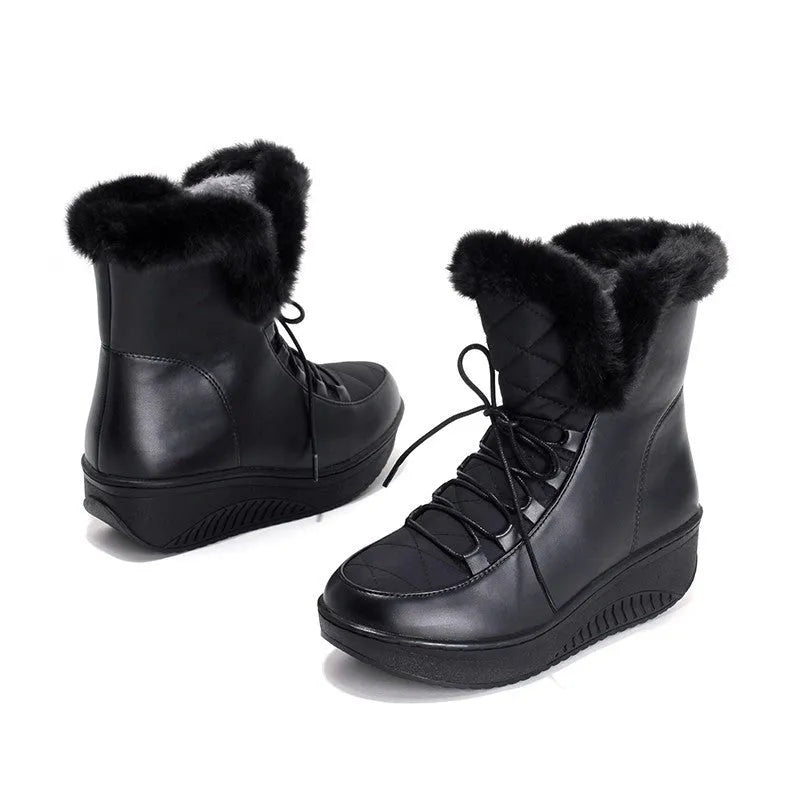 Women's black lace-up winter boots with a platform sole on a white background