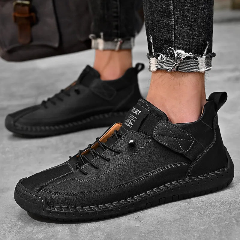 Men's mid-top Martin boots in black with tooling stitching detail and elastic band side entry