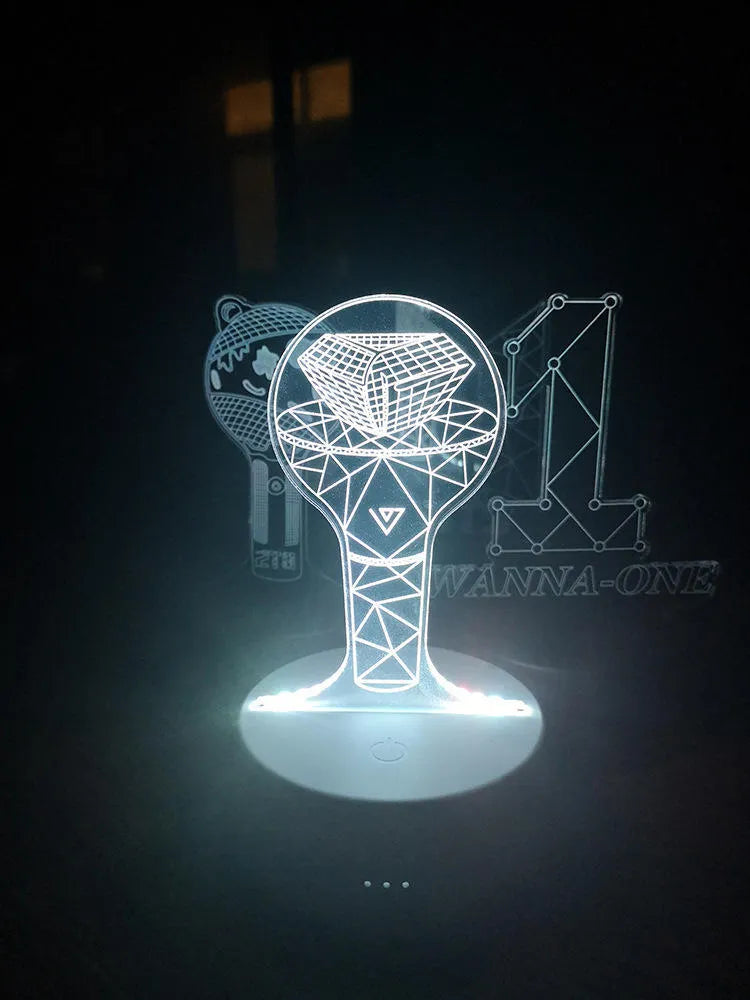 Transparent acrylic display stand showing illuminated BTS Light 101 Tower Gem collectible lamp.