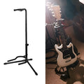 Black folding guitar stand holding an acoustic guitar, showing rubber contact points on neck and body supports.