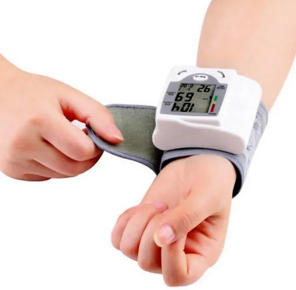 Grey wrist blood pressure monitor with compact rectangular design and display screen