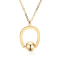 Gold electroplated stainless steel necklace with geometric pendant on an adjustable chain.